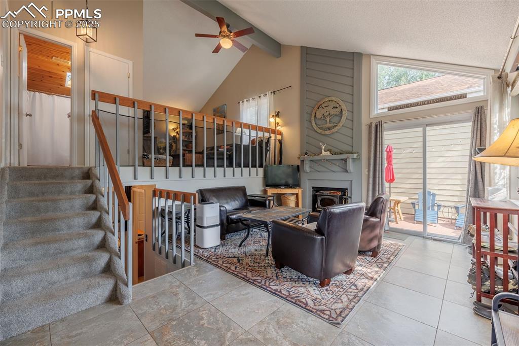 Image 3 of 15: Living room, beam ceiling, high vaulted ceiling, and a fireplace