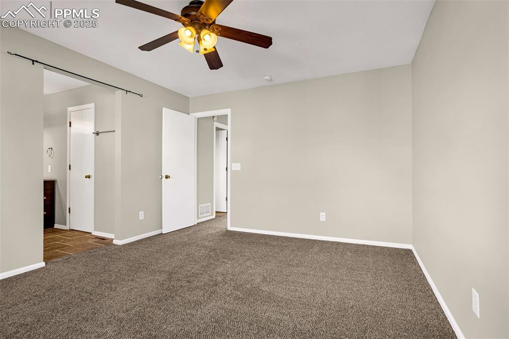 Image 8 of 14: Large Master bed with walkin closet and attached bath.