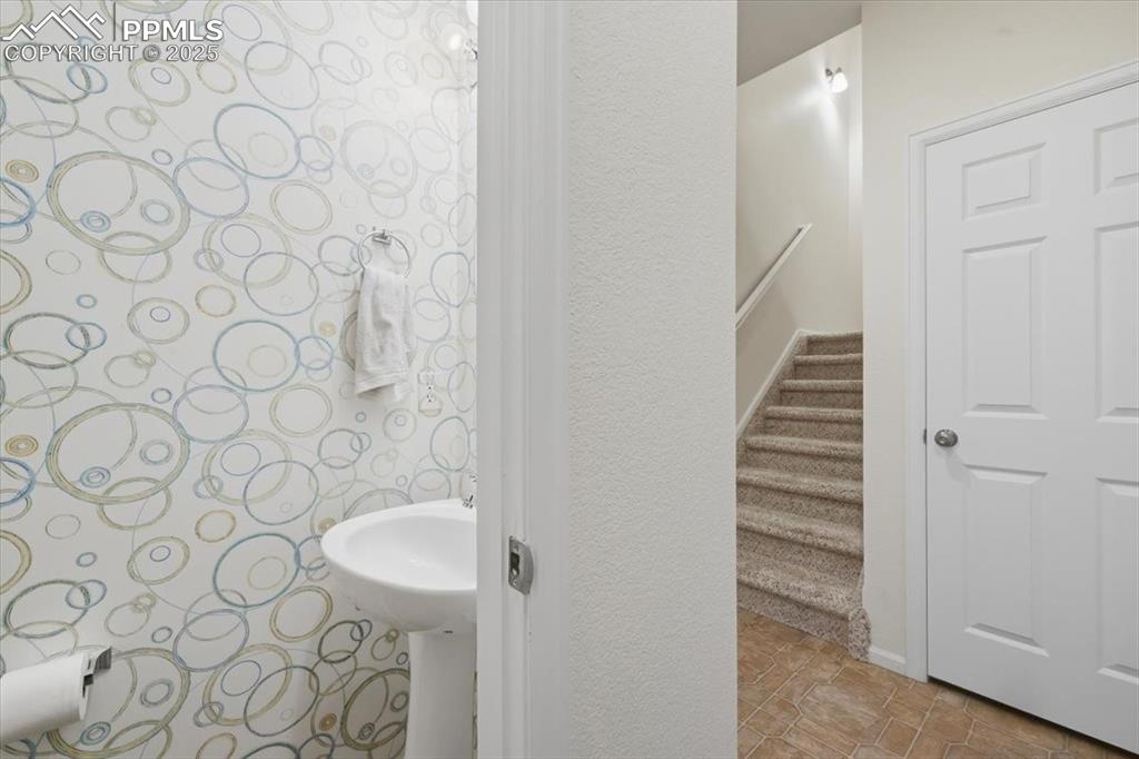 Image 12 of 32: main level guest bathroom.