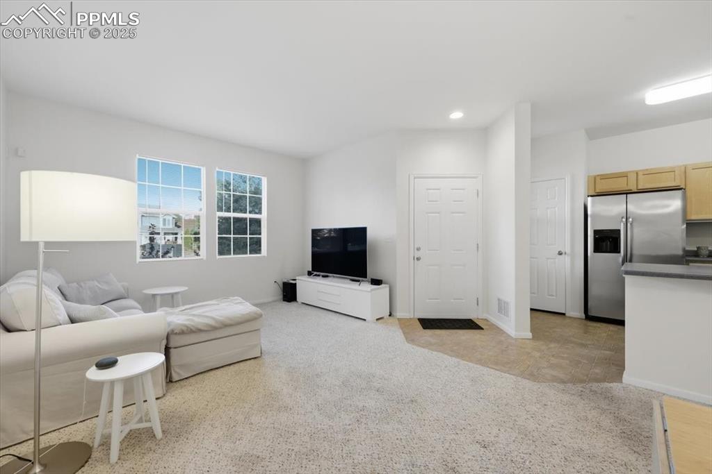 Image 6 of 32: Front entry into the living room. Very open.