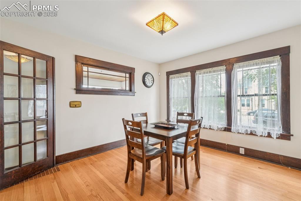 Image 15 of 49: Dining space with light wood-type flooring and large windows