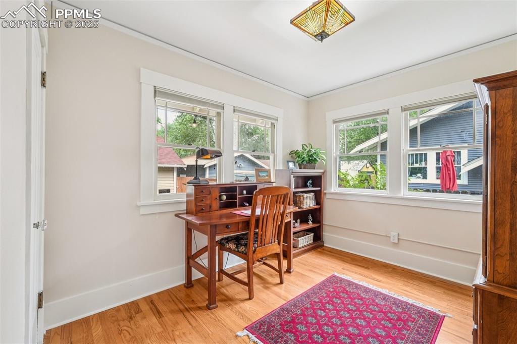 Image 20 of 49: Home office featuring light wood-style floors and ornamental molding