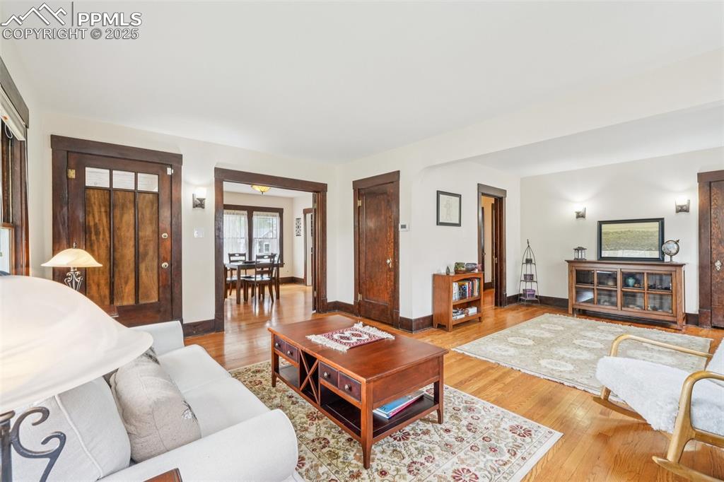 Image 3 of 49: Living room featuring light wood finished floors and baseboards
