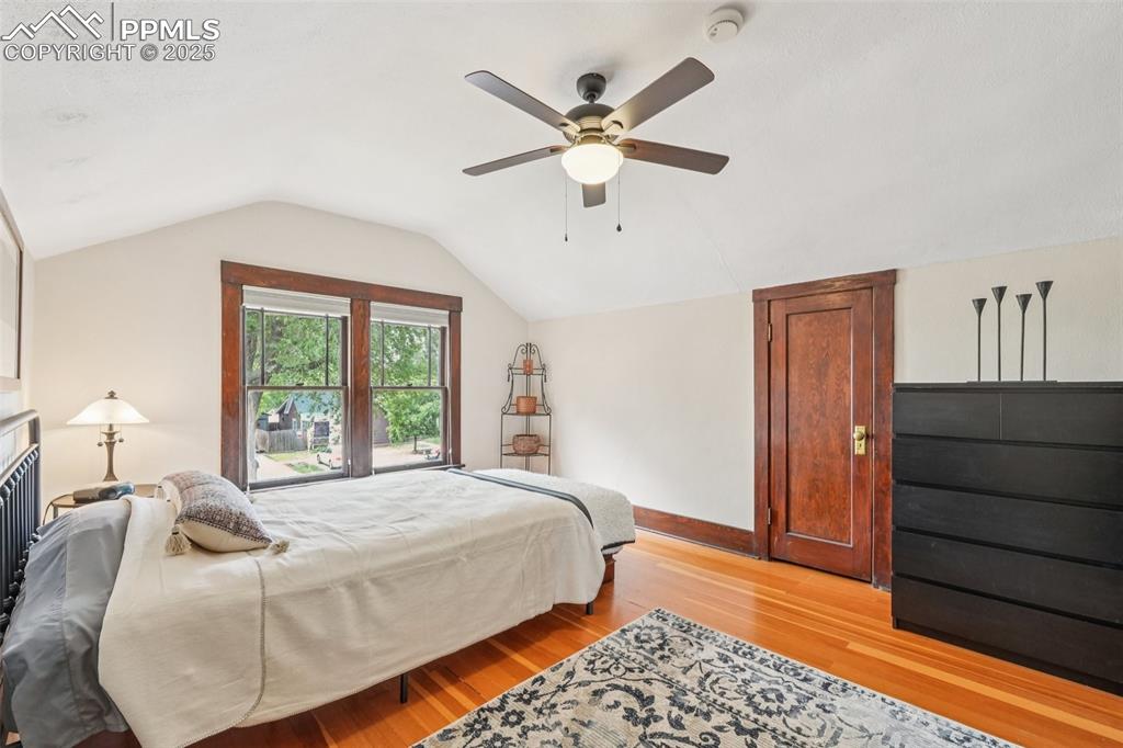 Image 30 of 49: Bedroom featuring light wood finished floors, lofted ceiling, extra closets