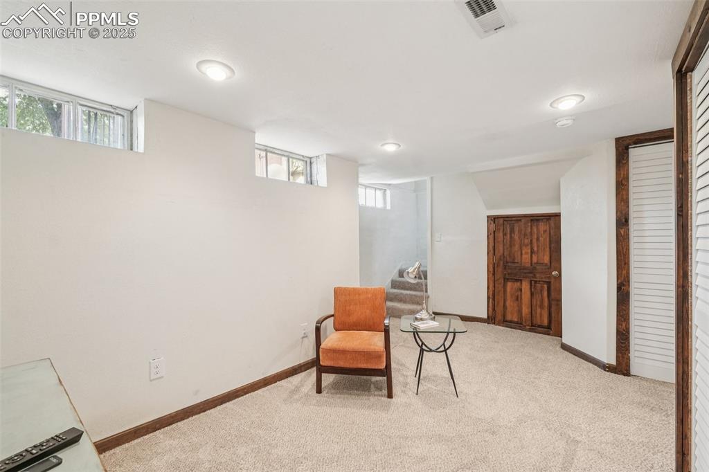 Image 34 of 49: Downstairs sitting room featuring light colored carpet, healthy amount of n