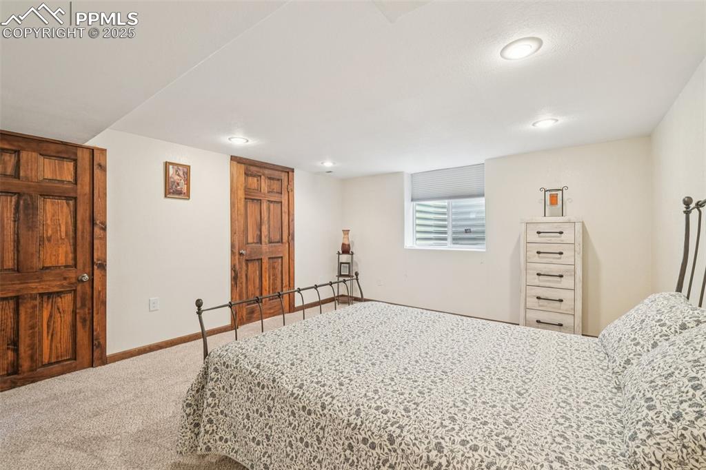 Image 38 of 49: Carpeted bedroom with recessed lighting and baseboards