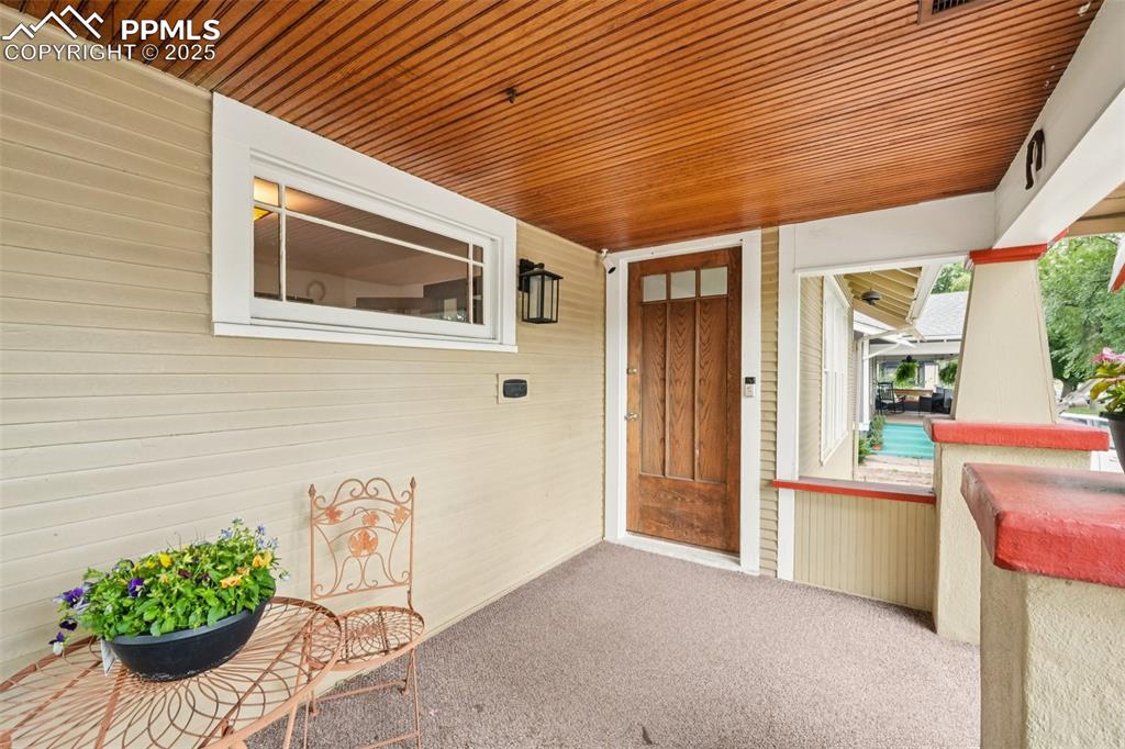 Image 9 of 49: Entrance to property featuring a porch