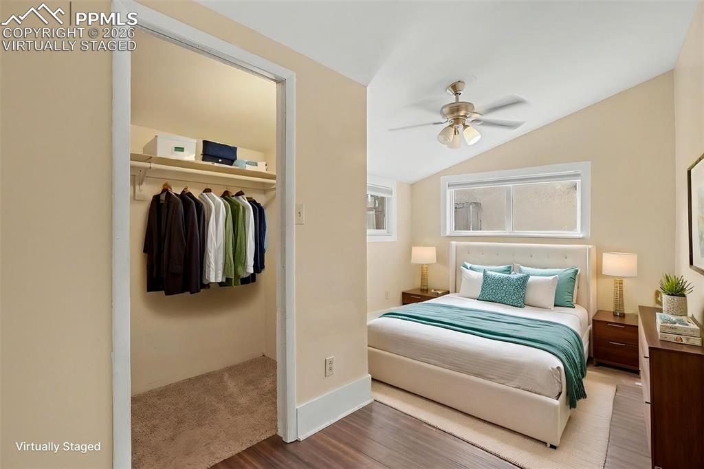 Image 17 of 24: Main level bedroom, virtually staged.