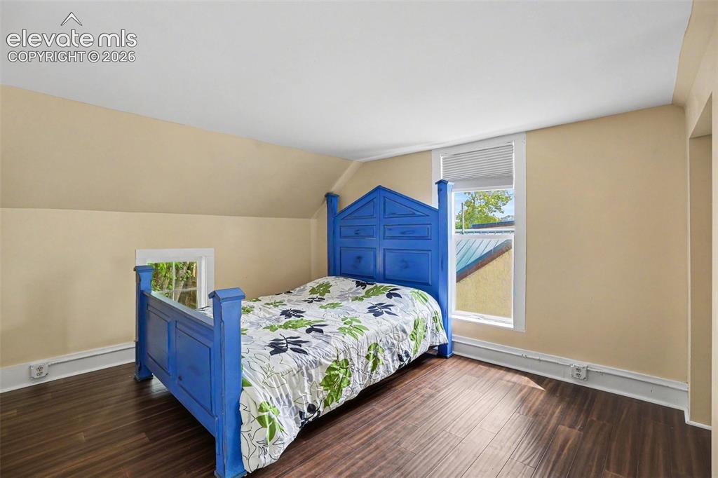 Image 19 of 23: Secondary upstairs bedroom.