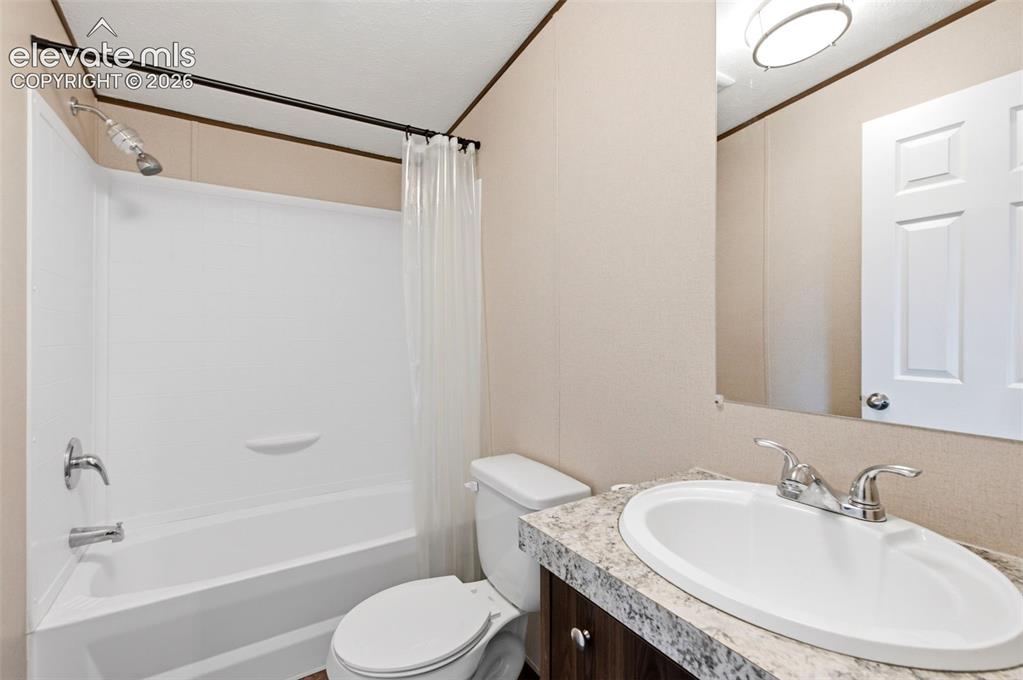 Image 15 of 32: Bathroom featuring a white tub/shower combination with chrome fixtures, a w