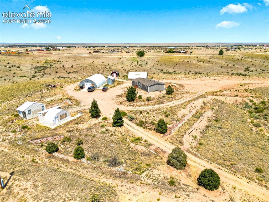 Image 27 of 32: Expansive property featuring multiple structures including a primary reside