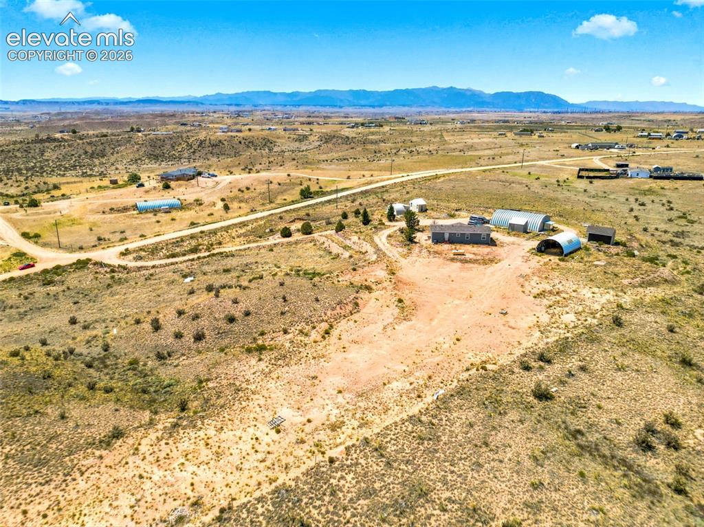 Image 31 of 32: Expansive rural property featuring multiple outbuildings, including quonset