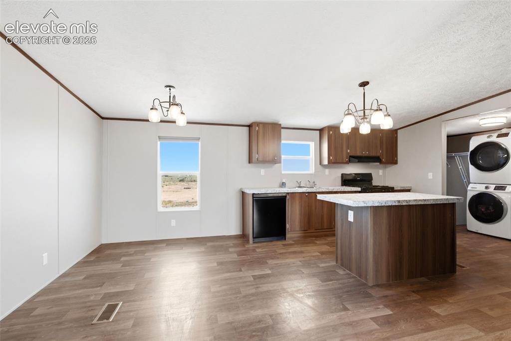 Image 5 of 32: Open-concept kitchen and dining area featuring wood-finish flooring, a kitc