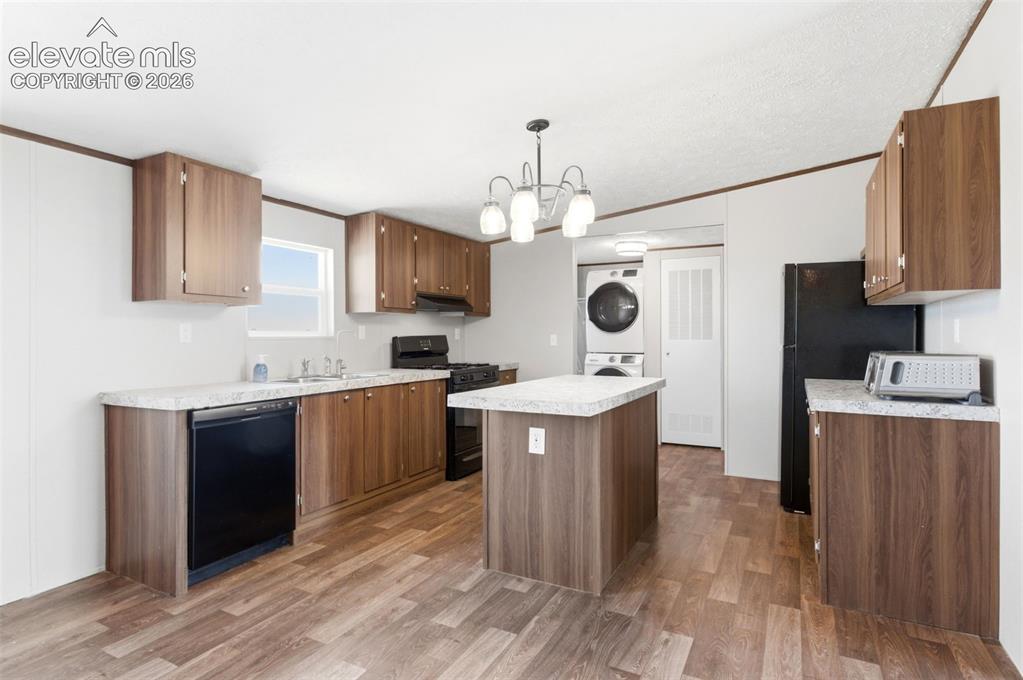 Image 6 of 32: Kitchen featuring wood-finish flooring, wood-tone cabinetry, light-toned co