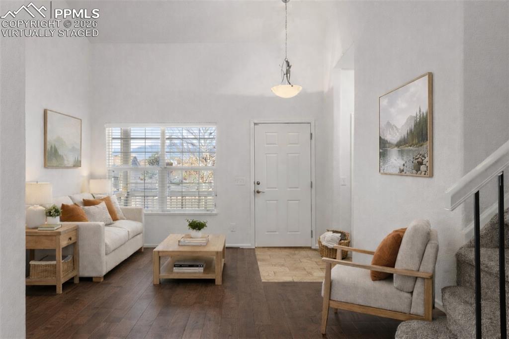 Image 4 of 37: Living room featuring dark wood-style flooring and a high ceiling. virtuall