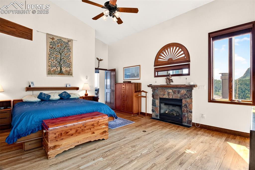 Image 14 of 50: Primary bedroom with gas burning fireplace, a walk out to back deck w/hot t