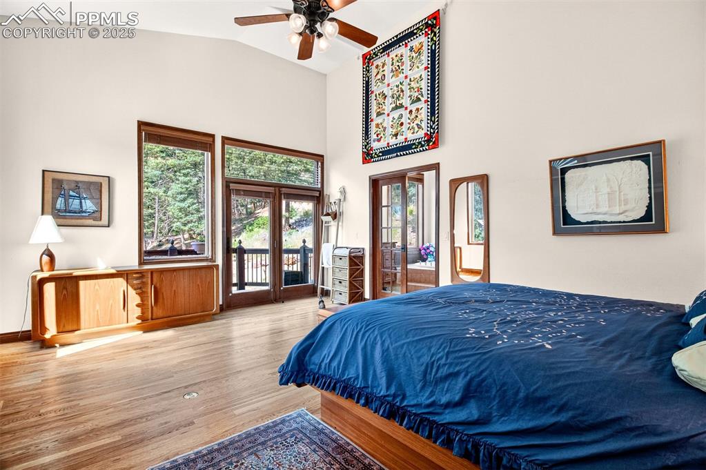 Image 15 of 50: Primary bedroom with walk out to deck with hot tub, an en suite bathroom an