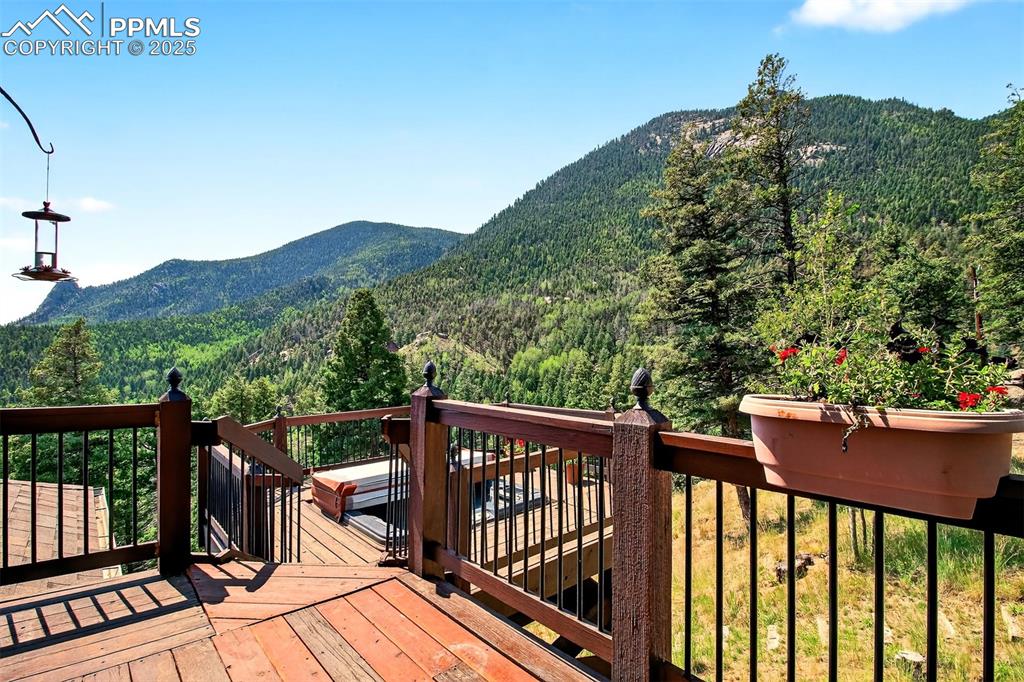Image 19 of 50: Deck off primary bedroom with hot tub and views Sentinel rock and the surro
