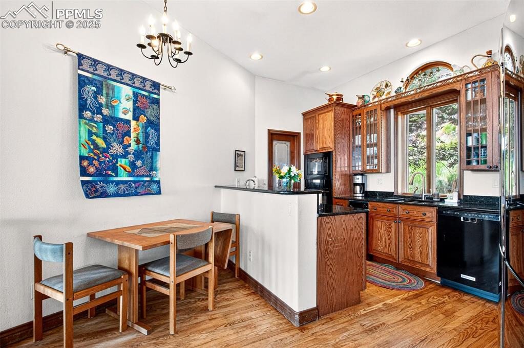 Image 25 of 50: Kitchen with granite countertops, pantry, an island, breakfast area, a gas 
