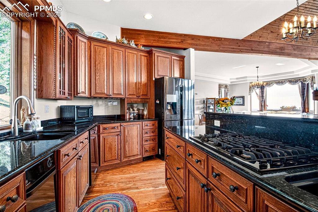 Image 26 of 50: Kitchen with granite countertops, pantry, an island, breakfast area, a gas 