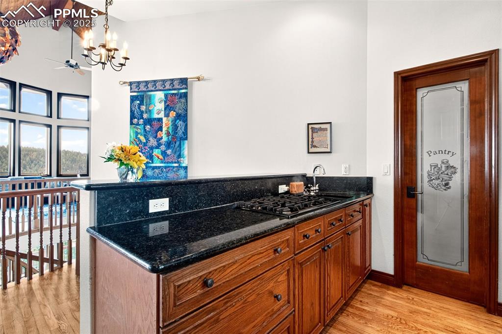 Image 27 of 50: Kitchen island with walk in pantry ands breakfast area