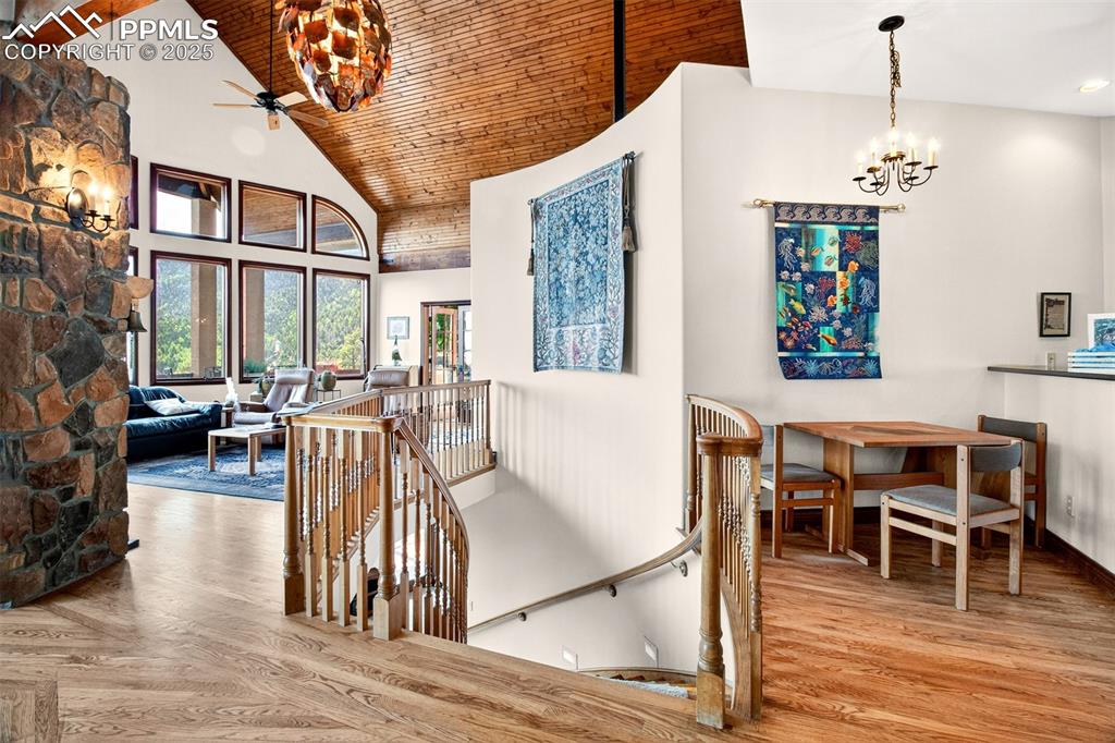 Image 30 of 50: Upper level landing heading to lower level. Notice the custom copper pineco