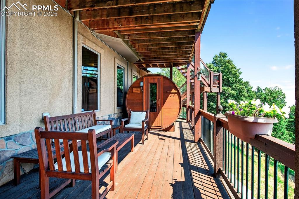 Image 33 of 50: Covered lower level deck with sauna