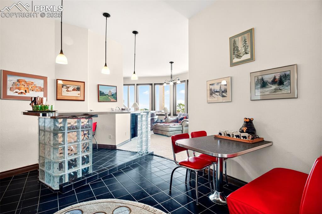 Image 36 of 50: Wet bar with seating on the lower level by media room