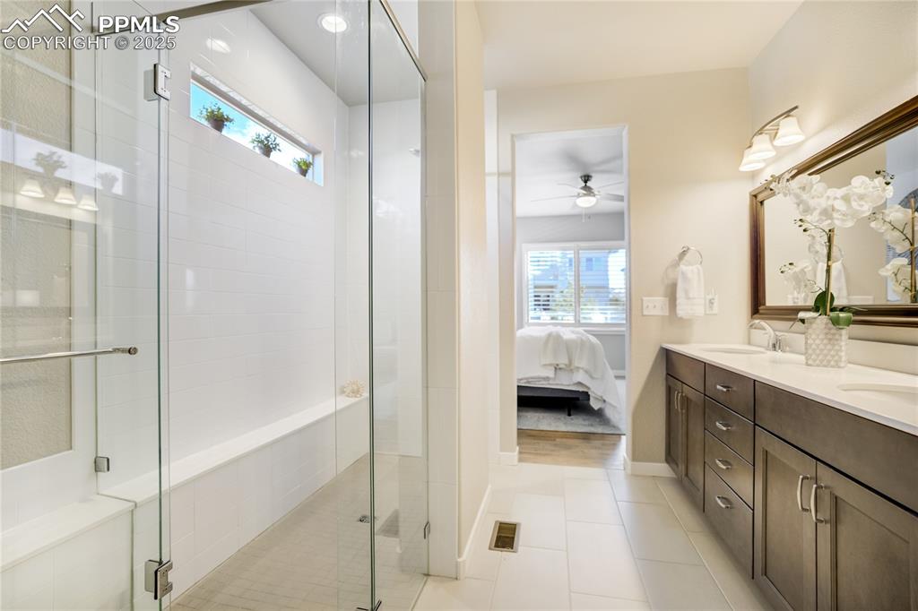 Image 22 of 50: Modern and tranquil—frameless Spa-like walk-in shower, tile flooring, and d