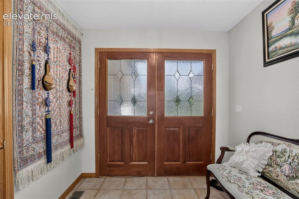 Image 12 of 49: Front entrance foyer with mud room area.