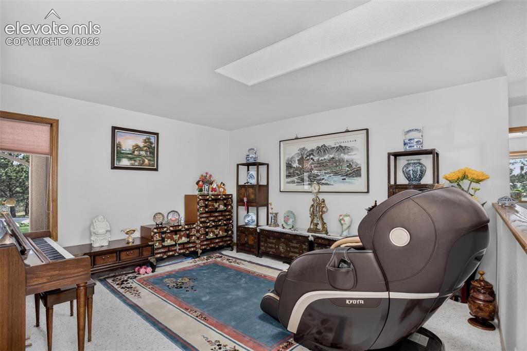 Image 14 of 49: Formal living room with skylights. 