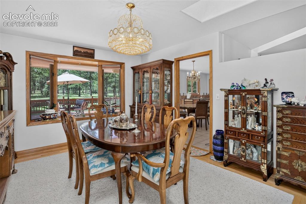 Image 15 of 49: Formal dining area with skylights and access to kitchen. 