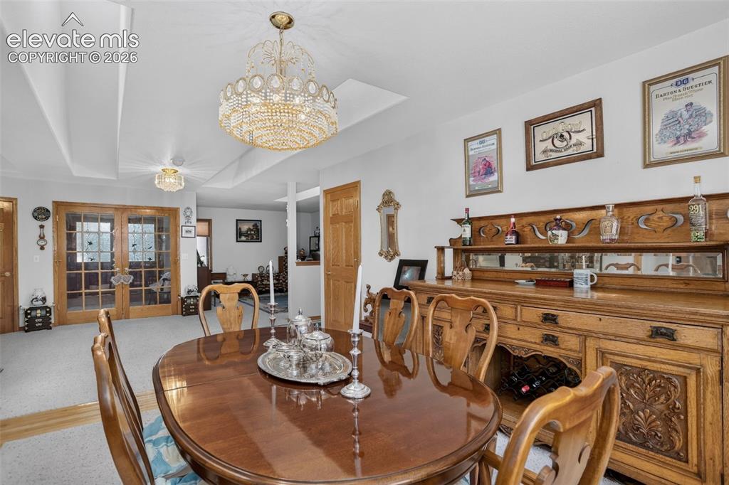 Image 16 of 49: Formal dining area with skylights and access to kitchen. 