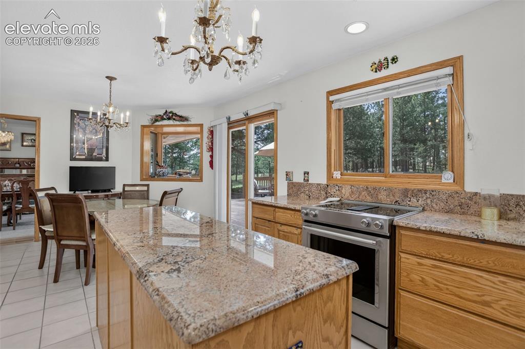 Image 19 of 49: Kitchen with breakfast area and walk out to back deck. 