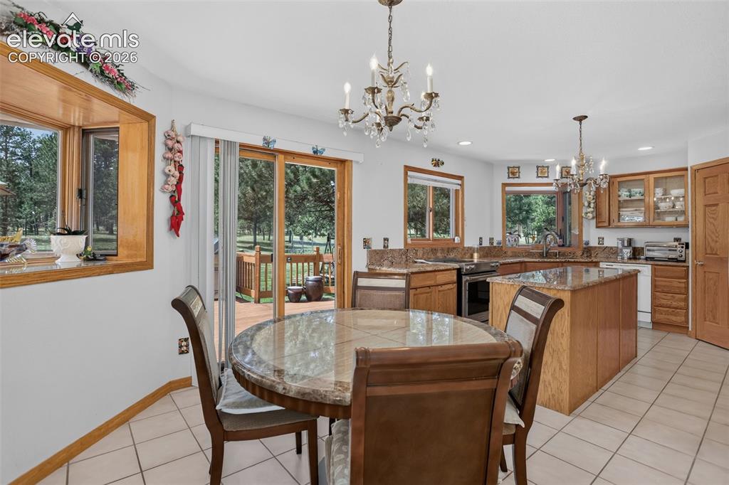Image 20 of 49: Breakfast area in kitchen with walk out to back deck.