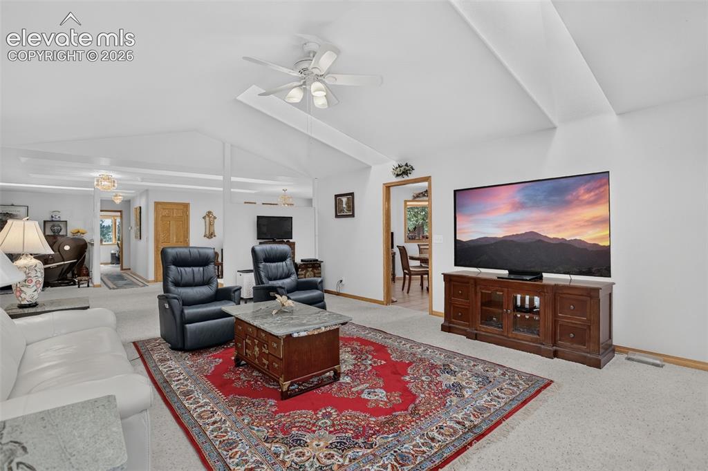 Image 22 of 49: Family room with open layout to kitchen, dining, and formal living room.