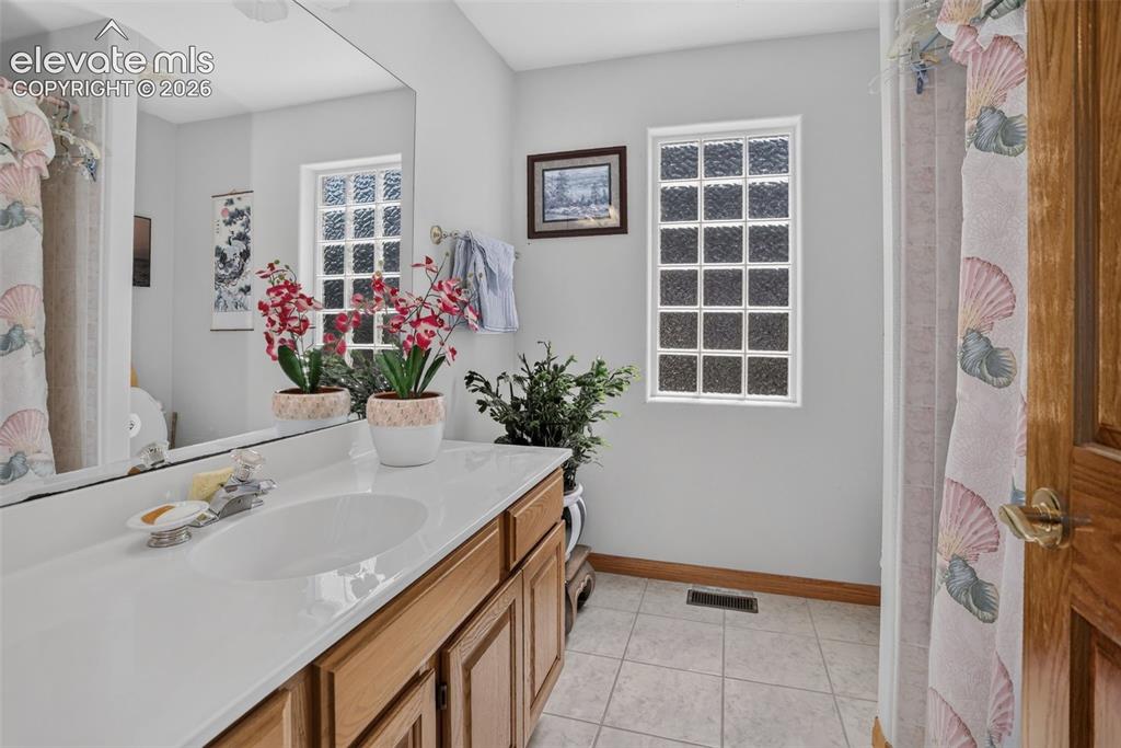 Image 33 of 49: Full bathroom with large single vanity and tub/shower. 