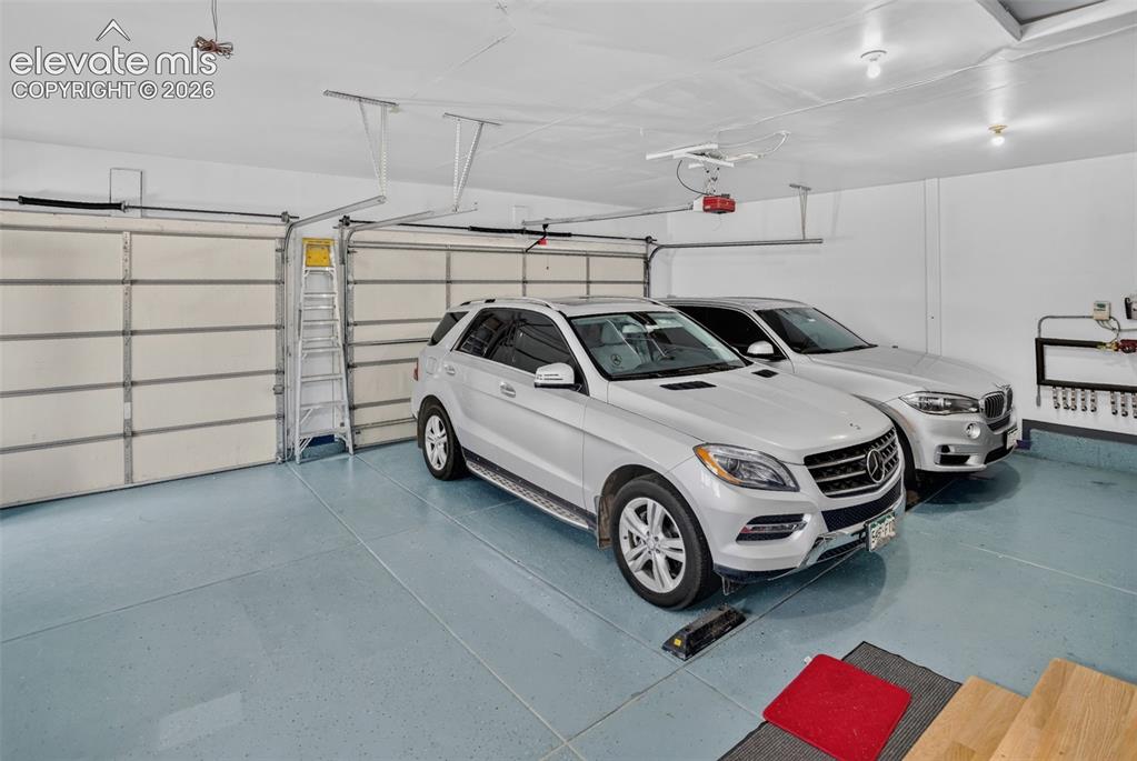 Image 38 of 49: Oversized garage with fresh epoxy coat on floor.