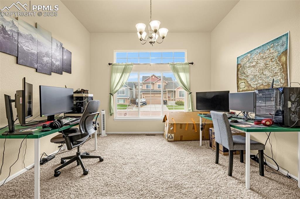 Image 12 of 36: Carpeted office featuring a chandelier and baseboards