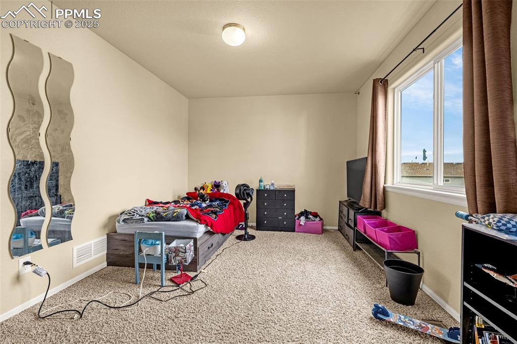 Image 25 of 36: Recreation room with carpet