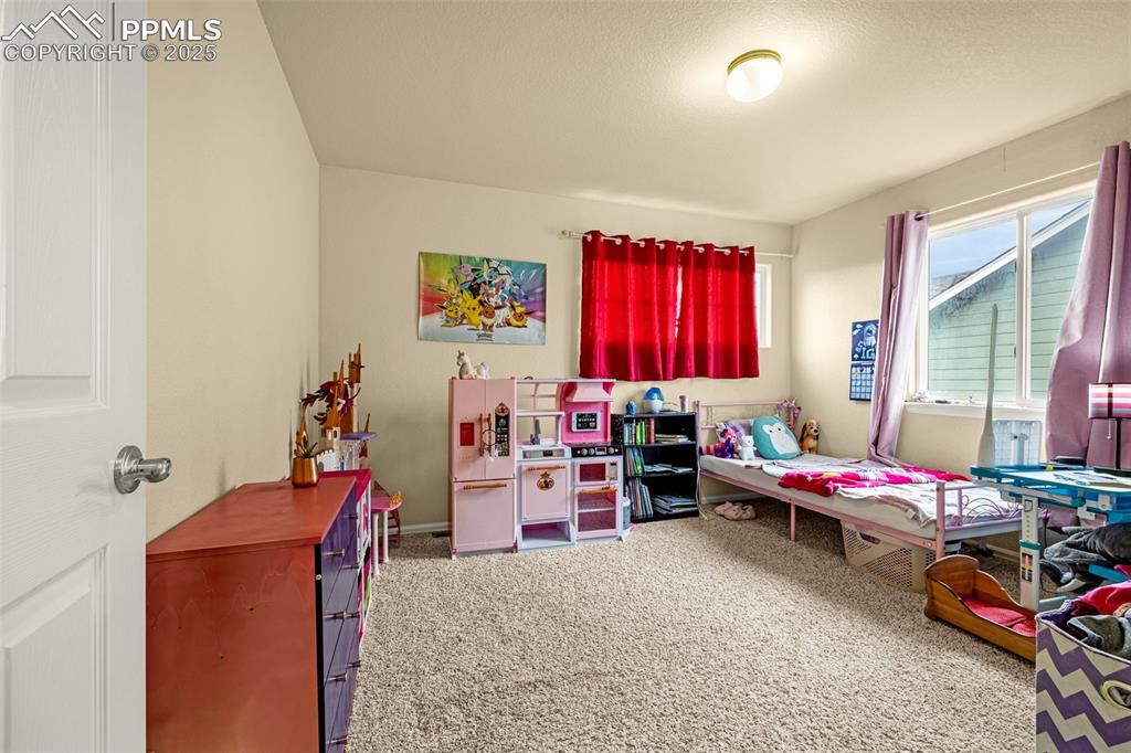 Image 28 of 36: Bedroom featuring light colored carpet and baseboards
