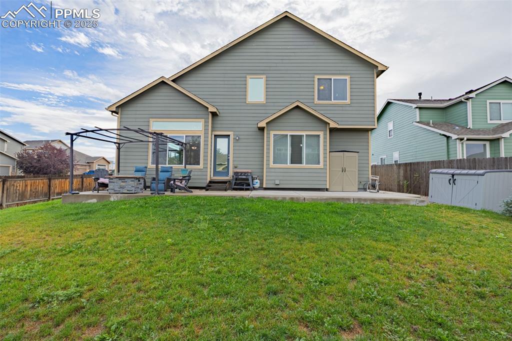 Image 29 of 36: Rear view of property with a fenced backyard, a patio, and a shed