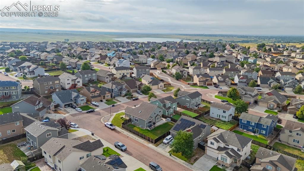 Image 33 of 36: View of property location featuring a nearby body of water and nearby subur