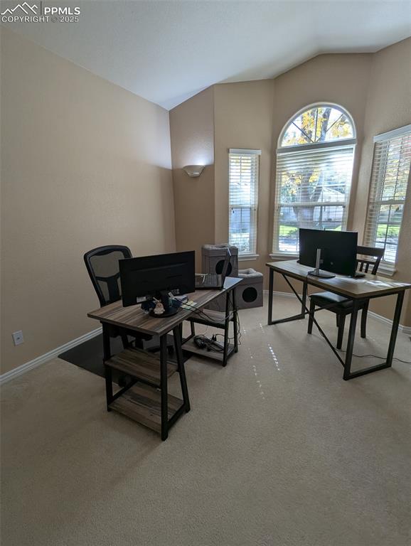 Image 14 of 33: Office area featuring lofted ceiling and light carpet