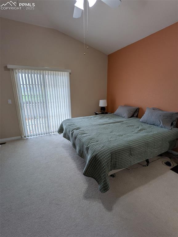 Image 15 of 33: Bedroom featuring vaulted ceiling, access to outside, carpet flooring, and