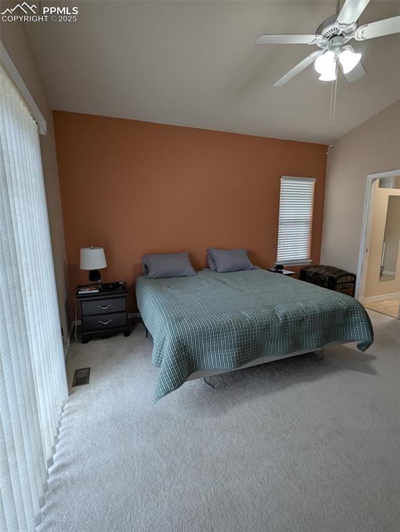Image 16 of 33: Carpeted bedroom with ceiling fan