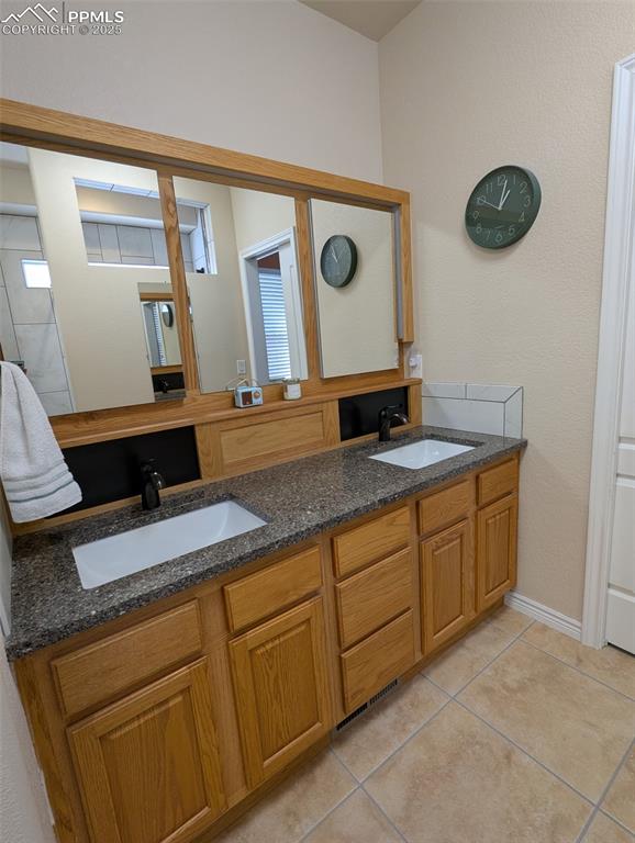 Image 17 of 33: Full bathroom featuring double vanity and light tile patterned flooring