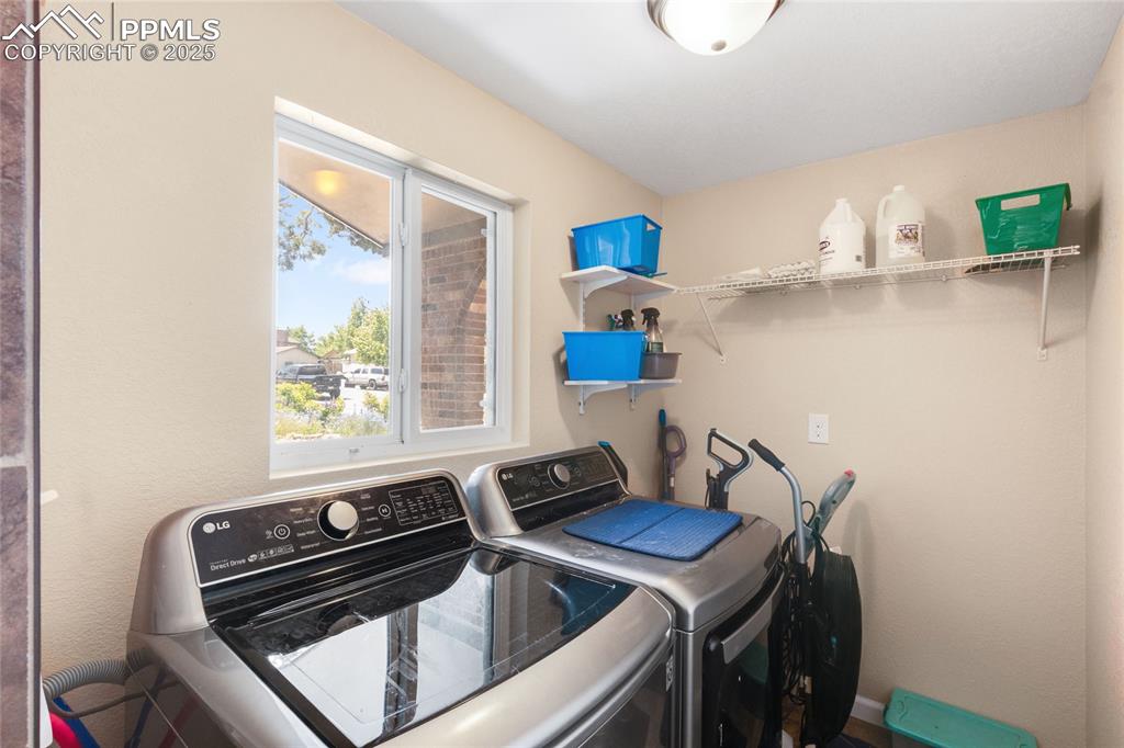 Image 27 of 43: Laundry room with washing machine and clothes dryer