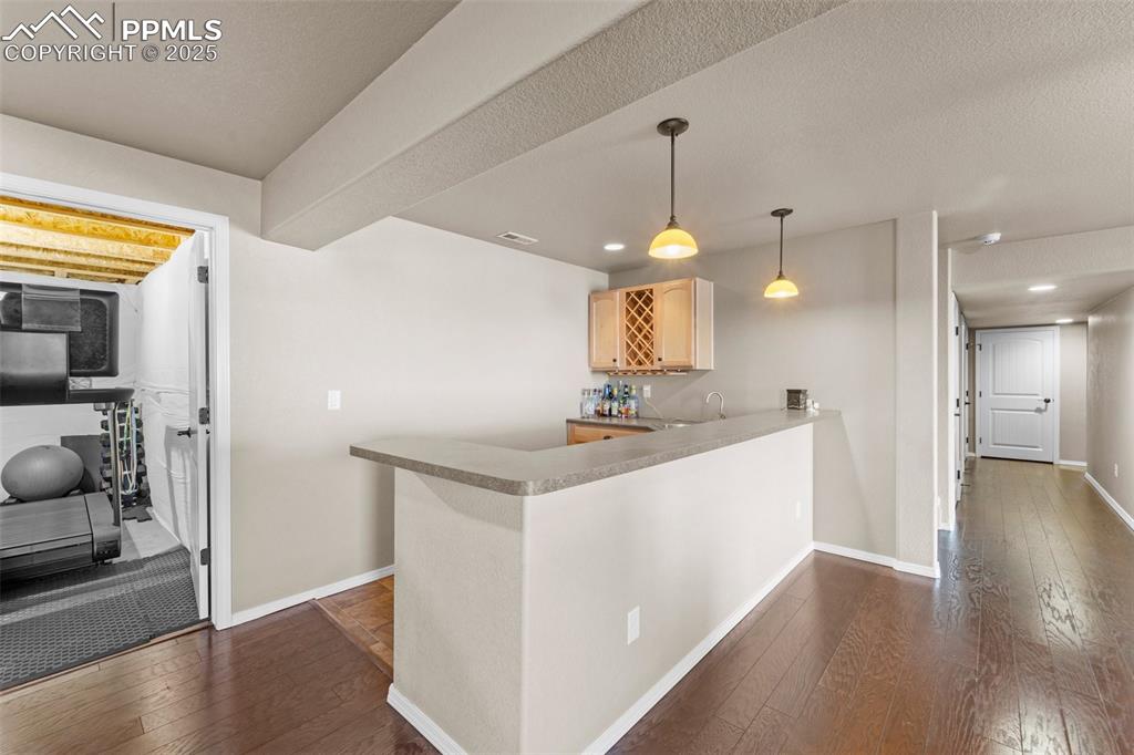 Image 29 of 50: Kitchen featuring light brown cabinetry, sink, dark hardwood / wood-style f