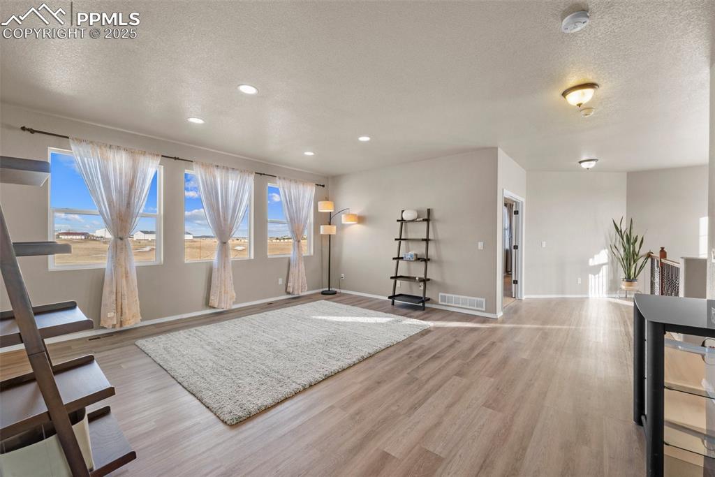 Image 35 of 50: Foyer with a textured ceiling and light wood-type flooring
